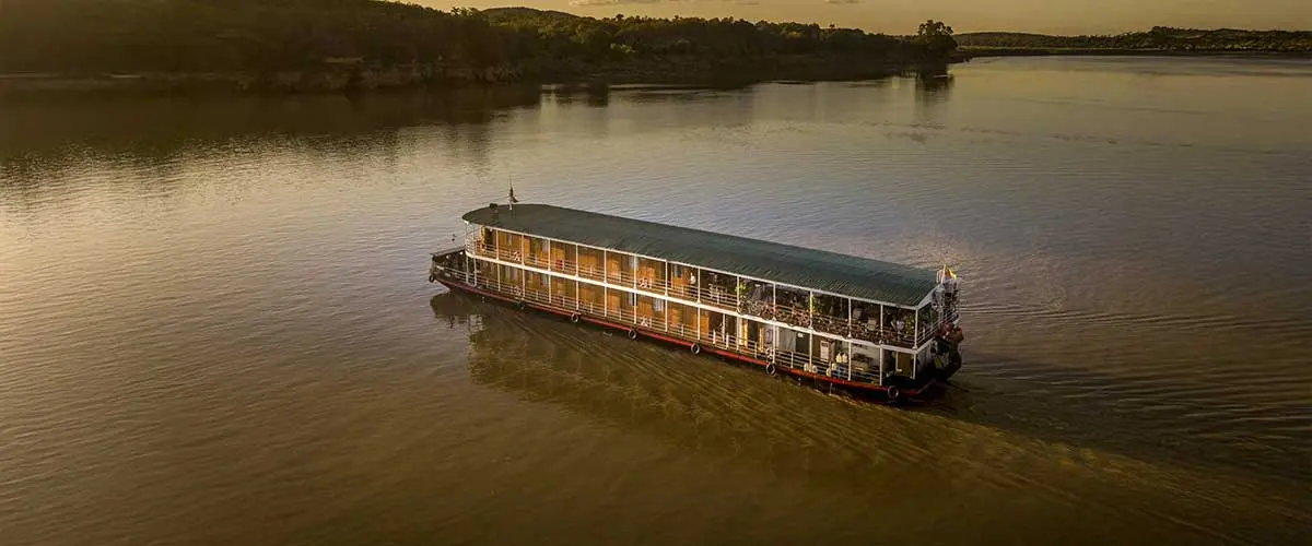 Paul Strachan with early converted river boat on the Irrawaddy